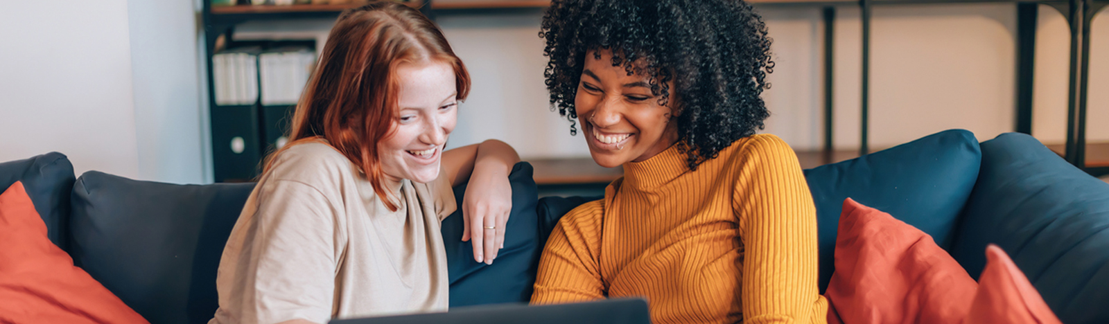 Two young women looking at a laptop