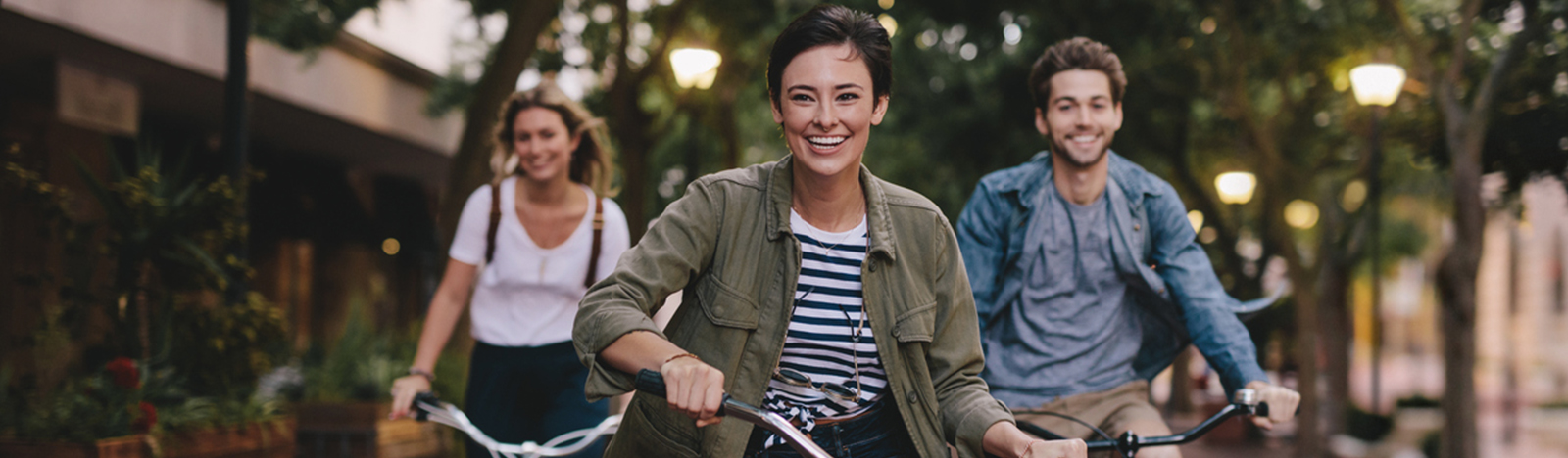 Group of young adults riding bikes through the city