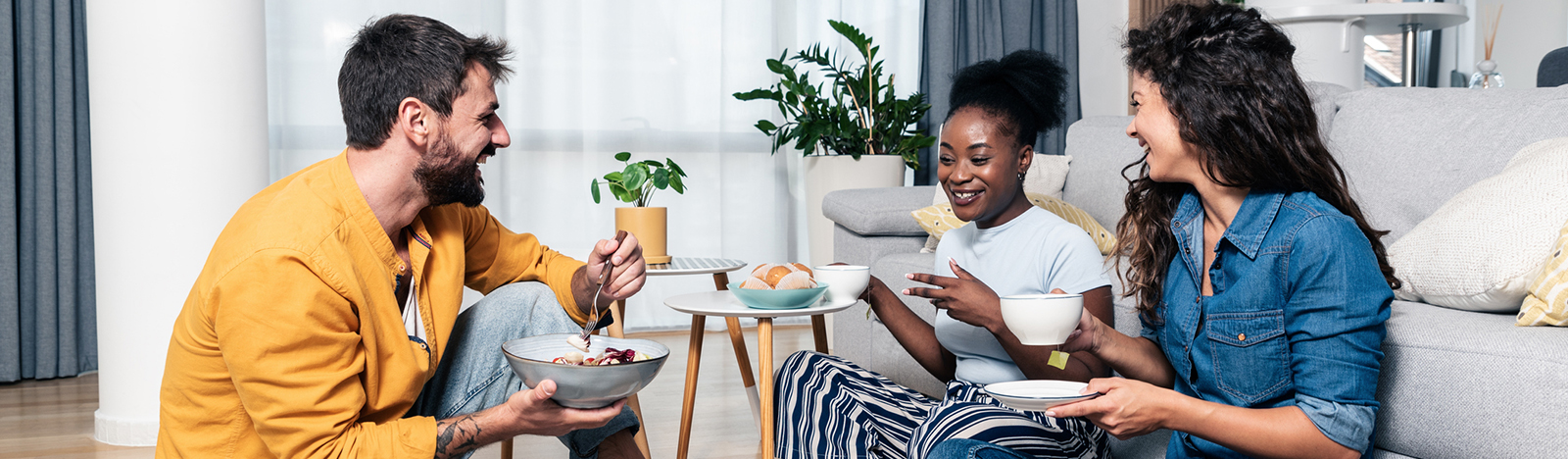 Group of young adults enjoying a meal at home